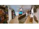 Living room with large TV, leather couch, and extensive shelving at 906 Bluewater Dr, Sun City Center, FL 33573