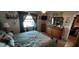 Main bedroom with a large bed, dresser, and window with curtains at 906 Bluewater Dr, Sun City Center, FL 33573