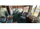 Relaxing sunroom with wicker furniture and lake view at 906 Bluewater Dr, Sun City Center, FL 33573