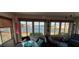 Bright sunroom with lake view and wicker furniture at 906 Bluewater Dr, Sun City Center, FL 33573