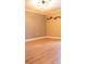 Bright bedroom featuring neutral walls, hardwood flooring, and modern lighting fixture at 11410 8Th N Way # 310, St Petersburg, FL 33716