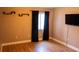 Bedroom features hardwood flooring, neutral colored walls, and a window with black curtains at 11410 8Th N Way # 310, St Petersburg, FL 33716