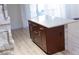 Close up view of kitchen island with wooden drawers, light granite top, and stone finish at 11410 8Th N Way # 310, St Petersburg, FL 33716
