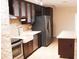 Kitchen featuring stainless steel appliances, stone island and wooden cabinets at 11410 8Th N Way # 310, St Petersburg, FL 33716