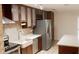 Modern kitchen featuring stainless steel appliances, wood cabinets, and a farmhouse sink at 11410 8Th N Way # 310, St Petersburg, FL 33716