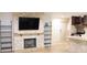 Open concept living room featuring a stone fireplace and shelving at 11410 8Th N Way # 310, St Petersburg, FL 33716