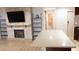 Open concept living room featuring a stone fireplace and shelving at 11410 8Th N Way # 310, St Petersburg, FL 33716