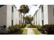 Exterior of the property with well-maintained landscaping and path to the units at 11410 8Th N Way # 310, St Petersburg, FL 33716