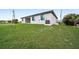 View of the back of the house with a large grassy backyard at 16229 Cape Horn Blvd, Punta Gorda, FL 33955