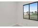 Simple bedroom with large window and neutral walls at 16229 Cape Horn Blvd, Punta Gorda, FL 33955