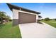 Brown garage door and spacious driveway in front of the house at 16229 Cape Horn Blvd, Punta Gorda, FL 33955