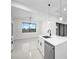 Kitchen island with white quartz countertop and stainless steel dishwasher at 16229 Cape Horn Blvd, Punta Gorda, FL 33955