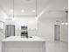 Modern kitchen with white cabinets, stainless steel appliances, and island at 16229 Cape Horn Blvd, Punta Gorda, FL 33955