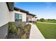 Side view of the house showing a walkway and landscaping at 16229 Cape Horn Blvd, Punta Gorda, FL 33955