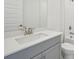 Modern bathroom with gray vanity and a white countertop at 14022 Ginnie Springs Way, Parrish, FL 34219