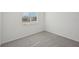 Well-lit bedroom featuring gray carpet and a window at 14022 Ginnie Springs Way, Parrish, FL 34219