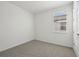 Spacious bedroom featuring grey carpet and a window with blinds at 14022 Ginnie Springs Way, Parrish, FL 34219