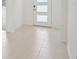 Light beige tile floor and a modern front door in an entryway at 14022 Ginnie Springs Way, Parrish, FL 34219