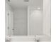 Clean bathroom with double vanity and shelving unit at 144 Lazy Shore Dr, Nokomis, FL 34275