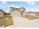 Two-story house with a light beige exterior, gray door, and two-car garage at 144 Lazy Shore Dr, Nokomis, FL 34275