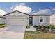 Newly constructed one-story home with gray exterior, two-car garage, and landscaped front yard at 169 Lazy Shore Dr, Nokomis, FL 34275