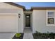 Front entrance with dark brown door and light gray walls at 169 Lazy Shore Dr, Nokomis, FL 34275