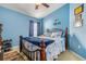 Bedroom with double bed, blue walls, and decorative wall art at 7851 Tuscany Woods Dr, Tampa, FL 33647