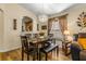 Dining area with chandelier, hardwood floors, and seating for six at 7851 Tuscany Woods Dr, Tampa, FL 33647