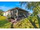 Home exterior showcasing a screened patio and lush lawn at 7851 Tuscany Woods Dr, Tampa, FL 33647