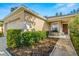 Front entrance of house with landscaping and walkway at 7851 Tuscany Woods Dr, Tampa, FL 33647