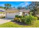 One-story home with attached garage and landscaped front yard at 7851 Tuscany Woods Dr, Tampa, FL 33647