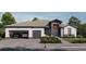 Modern two-car garage home with gray roof and landscaping at 17013 Alpenhorn Ct, Punta Gorda, FL 33955