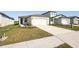 Newly built home with a two-car garage and front yard at 14040 Crutchfield Ct, Parrish, FL 34219