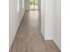 Light-filled hallway with wood-look tile flooring at 14040 Crutchfield Ct, Parrish, FL 34219