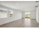 Bright living room showcasing wood-look tile floors and sliding glass doors at 14040 Crutchfield Ct, Parrish, FL 34219