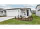 House exterior showcasing a garage and neatly landscaped yard at 14052 Crutchfield Ct, Parrish, FL 34219