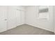 Simple bedroom with grey carpet, double door closet and window with blinds at 14053 Crutchfield Ct, Parrish, FL 34219