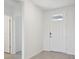 Bright entryway with white door and tile flooring at 7806 Gilchrist Springs Dr, Parrish, FL 34219