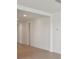 Long hallway with light walls and wood-look flooring at 7806 Gilchrist Springs Dr, Parrish, FL 34219