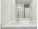 Bright bathroom featuring double vanity with white countertop and double sinks with large mirror at 7818 Gilchrist Springs Dr, Parrish, FL 34219