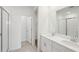 Bright bathroom featuring double vanity with white cabinets and tile flooring with glass enclosed shower at 7818 Gilchrist Springs Dr, Parrish, FL 34219