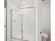 Bright bathroom featuring white tiled walls and glass shower doors at 7818 Gilchrist Springs Dr, Parrish, FL 34219