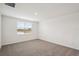 An empty bedroom with beige carpet, white walls, and a window offering natural light at 7818 Gilchrist Springs Dr, Parrish, FL 34219