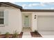 Close-up of a charming home entrance with a light teal door and well-maintained landscaping at 7818 Gilchrist Springs Dr, Parrish, FL 34219