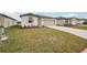 Attractive single-story home boasting a lush green lawn and a concrete driveway leading to an attached garage at 7818 Gilchrist Springs Dr, Parrish, FL 34219