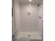 Bright bathroom features a white tiled shower and toilet at 2587 Blackwood Cir, Clearwater, FL 33763