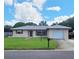 Ranch-style home with a spacious yard and attached garage at 2587 Blackwood Cir, Clearwater, FL 33763