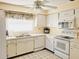 Updated kitchen boasts white cabinets, tiled floors, and a microwave at 2587 Blackwood Cir, Clearwater, FL 33763