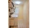 Bright laundry room with washer, dryer, and storage shelves at 2587 Blackwood Cir, Clearwater, FL 33763