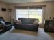 Living room with a couch, recliner, and large windows at 2587 Blackwood Cir, Clearwater, FL 33763